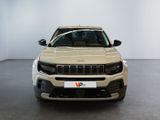 the front of a beige jeep compass parked in a white room