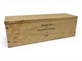 an old wooden box with a label on it sitting on a white surface