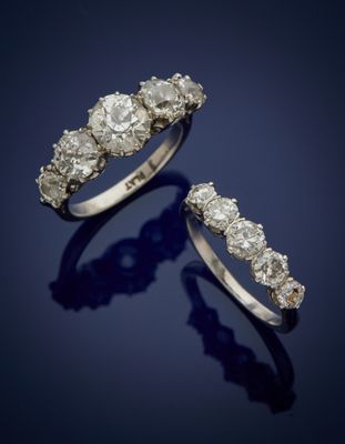a pair of diamond and platinum - plated rings