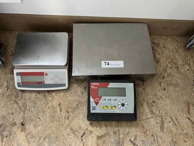 deux balances électroniques posées par terre l'une à côté de l'autre