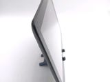 a tablet computer sitting on a stand on a white surface