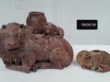 two figurines of animals and a bird on a table