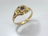 an image of a gold ring with a stone in the middle