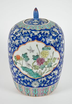 an image of a blue and white vase with a bird and flowers on it