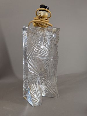 a silver glass bottle with a black top on a table
