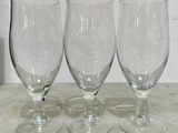 three empty wine glasses sitting on a table