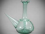 a green glass vase with a decorative design on it