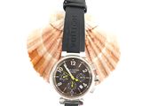 a watch that is sitting on top of a seashell