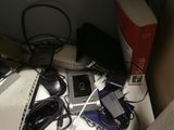a desk with a laptop, a keyboard, a mouse, and other electronics on it