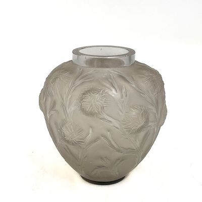 a glass vase with a design on it on a white surface