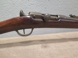 an old rifle is on display in a museum display case