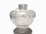 a glass vase that is sitting on top of a table