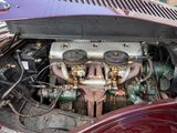 a car engine in the trunk of a red car