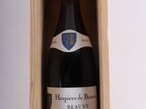 a bottle of wine in a wooden box on a table