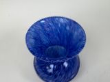 a blue vase that is sitting on a table