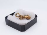 a close up of a ring in a black box on a white surface