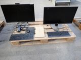 two computer monitors and a keyboard on a pallet