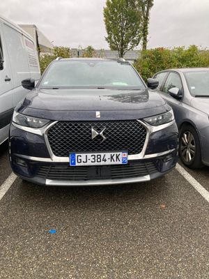 two cars parked in a parking lot next to each other