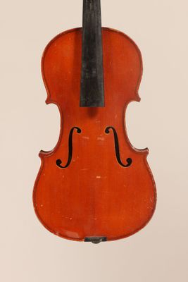 an old violin with a bow hanging from it ' s back