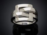 a close up of a ring on a black surface with a reflection