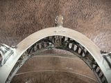 a close up of a toilet with a metal seat