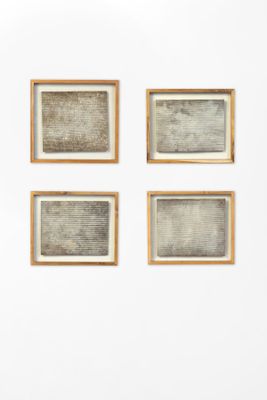 several pieces of artwork are hanging on a wall in a room
