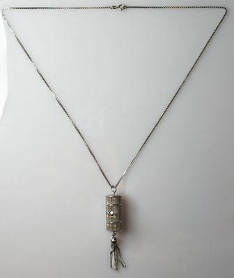 a silver necklace with a square pendant and a tassel hanging from it