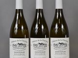 three bottles of wine sitting on top of a table next to each other