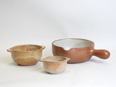 three bowls and a bowl on a white surface