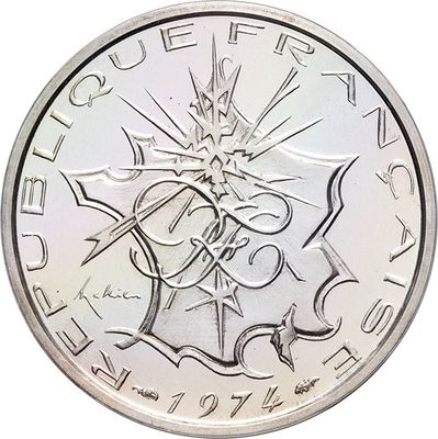 a close up of a silver coin with an image of a cross on it