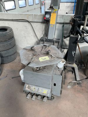 a machine that is sitting in a garage with tires