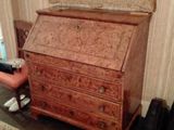 a small wooden desk with a mirror on top of it