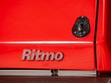 a close up of a red refrigerator with the word ritmo written on it