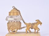 a gold figurine of a horse pulling a carriage with a man on it