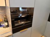 an image of a kitchen with a wine bottle on the counter