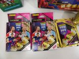 three packs of football trading cards sitting on top of a table