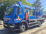 a blue truck that is parked on the side of the road