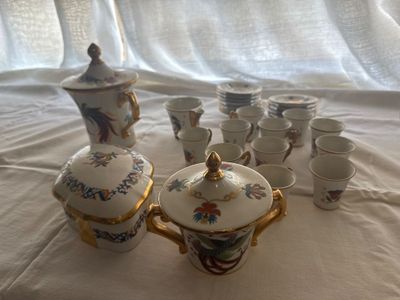 a lot of cups and a teapot on a table