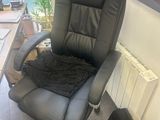 a black office chair with a black blanket on top of it