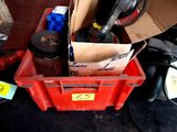 a pile of shoes and other items in a red box