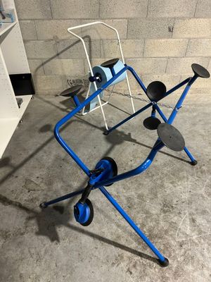 an image of a blue walker with wheels in a garage