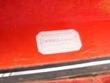 a close up of a red suitcase with a sticker on it