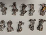 many figurines of different shapes and sizes on a white surface