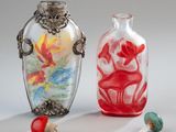 two glass vases sitting next to each other on a table