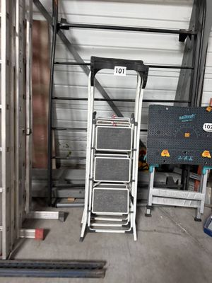 a picture of a ladder in a garage next to a sign