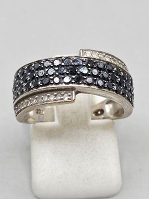 a close up of a ring with black and white diamonds