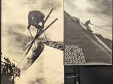 two posters on the wall of a building with skiers on them