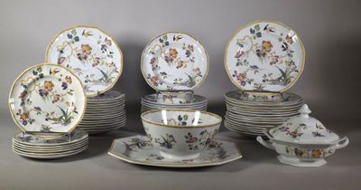 many plates and cups and saucers with flowers on them