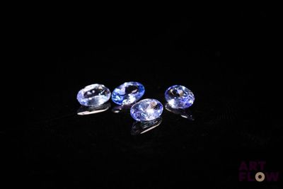 three blue sapphires on a black background