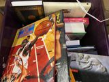 a purple box filled with books and other sports memorabilia